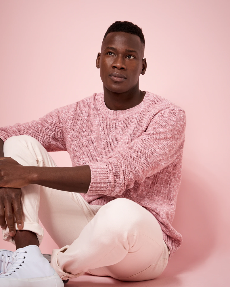 a young man on a pink background in a pink sweater and pink slacks from Banana Republic's spring 2021 collection