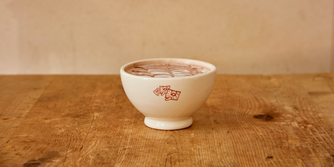 hot chocolate in a small porcelain cup from Le Pain Quotidien on a wooded table