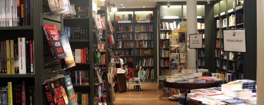 Inside of Shakespeare and Co with book filled shelves