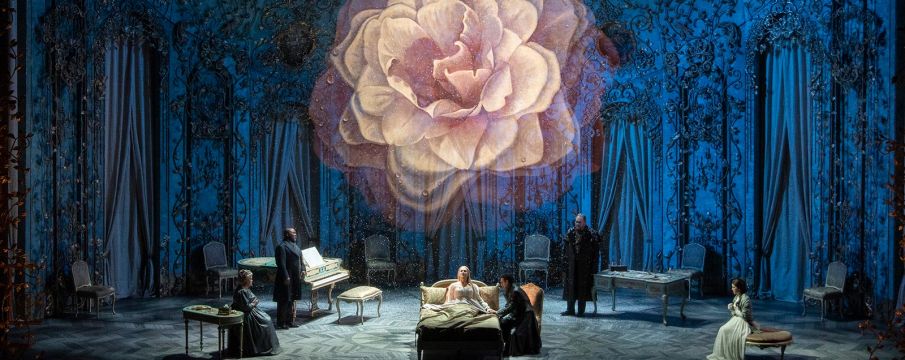 photo of the cast performing a scene from La Traviata on-stage at the Met Opera