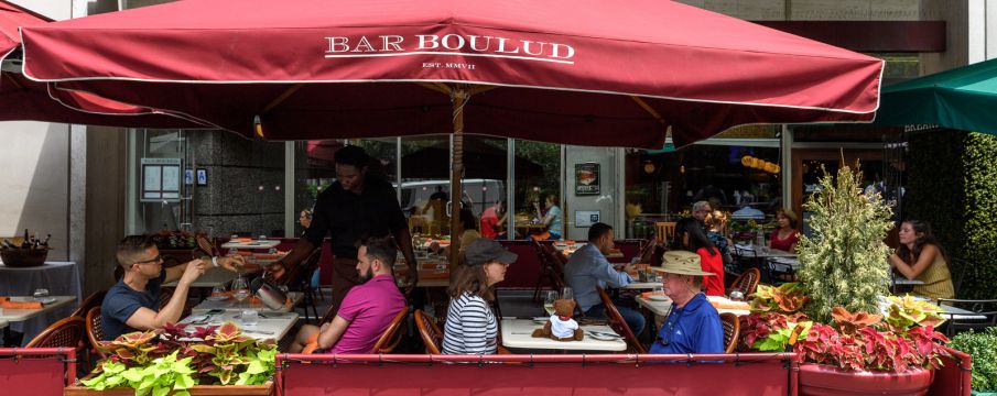 patrons enjoy outdoor seating at Bar Boulud on Broadway in the summer