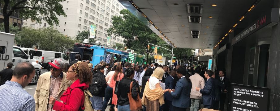 people gather in a crowd on the sidewalk in front of AMC Lincoln Center for Ad Week 2018