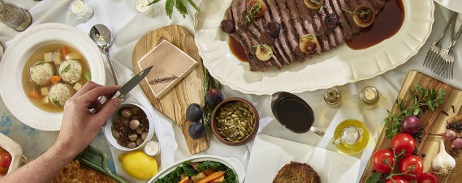 a spread of foods for Rosh Hashanah placed across a dinner table