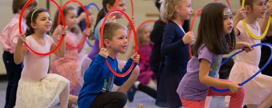 kids play with hula hoops at the NYC ballet