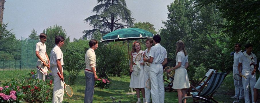 still from The Garden of the Finzi-Continis in which chatacters get ready to play a game of croquette in the summertime