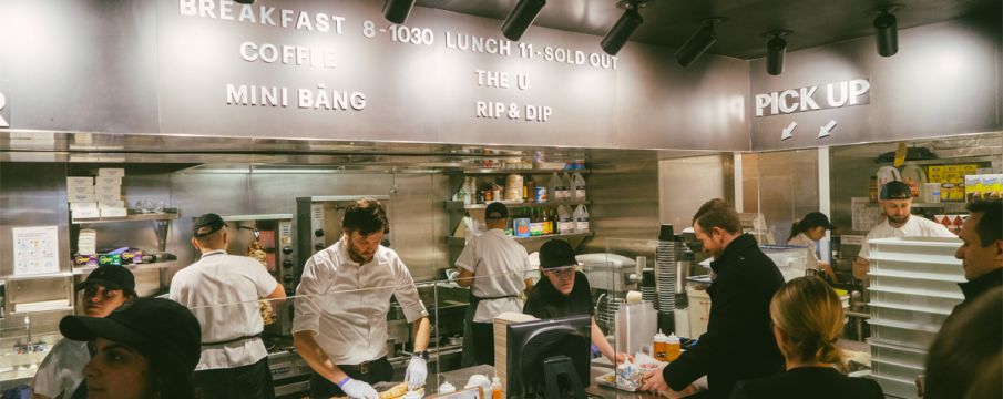 lunchgoers grab food from a busy Bang Bar counter in The Shops at Columbus Circle