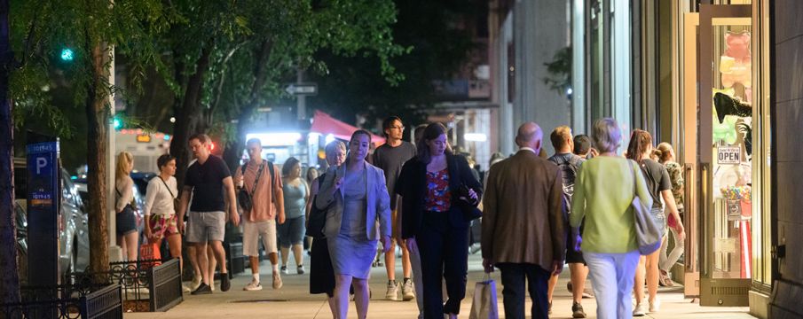 pedestrians walking down broadway in Lincoln Square on a fall evening 