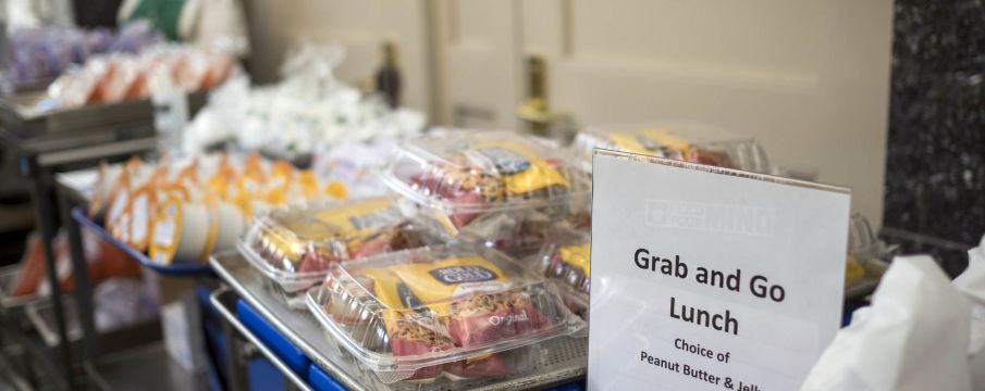 grab and go meals from DOE line up on a table ready to be handed out