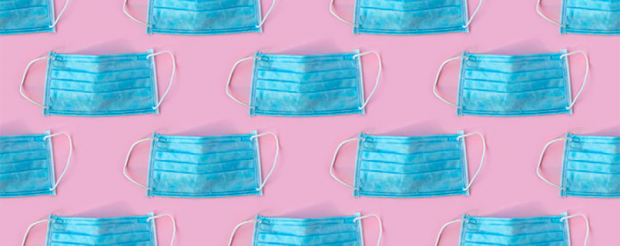 blue medical masks on a pink background