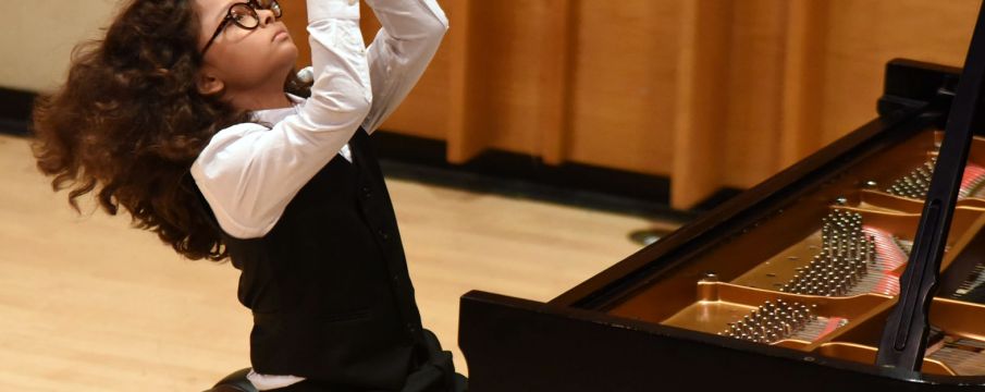 young boy playing piano