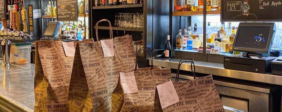 bags for take out line the counter of The Smith in Lincoln Square 