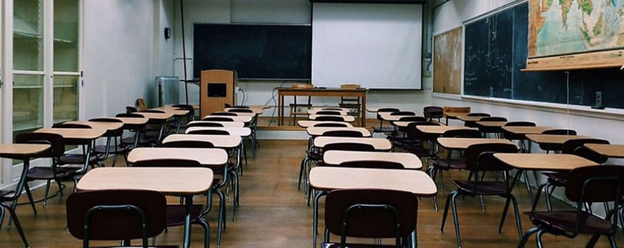 empty classroom with rows of desks