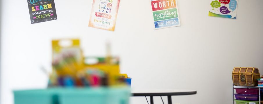 classroom space with tables and posters