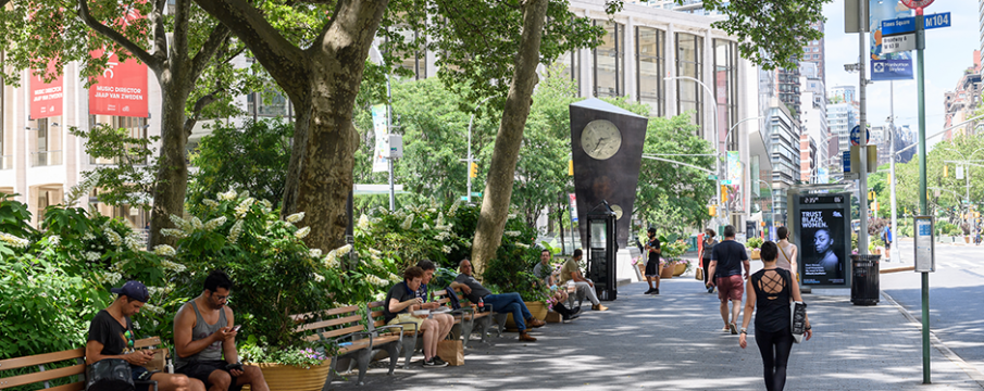 people walking and sitting in Dante Park