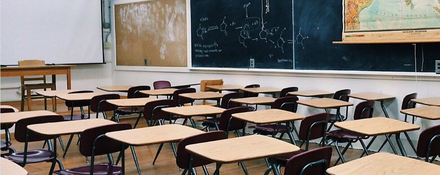 empty classroom with rows of desks