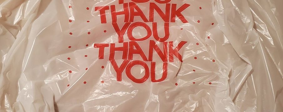 plastic bag with the words THANK YOU printed on it in a repeating pattern