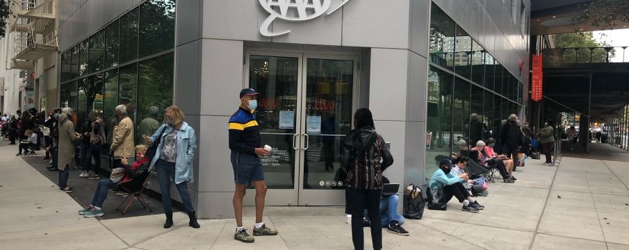 people standing outside david rubenstein atrium waiting to vote