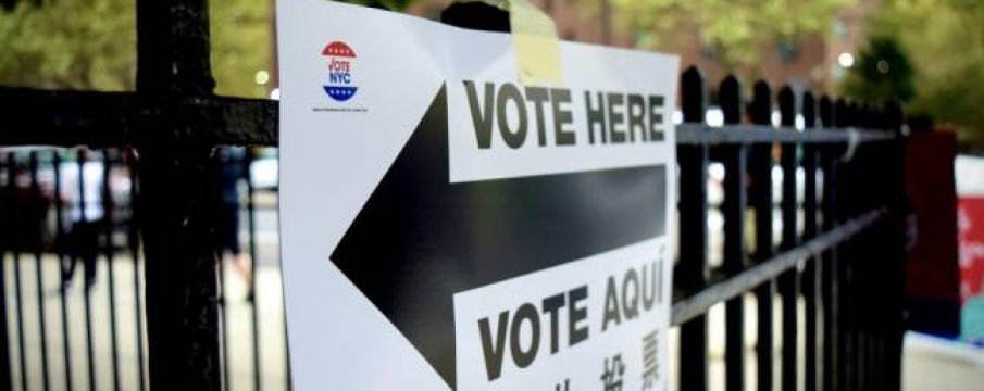 a sign pointing to a polling location