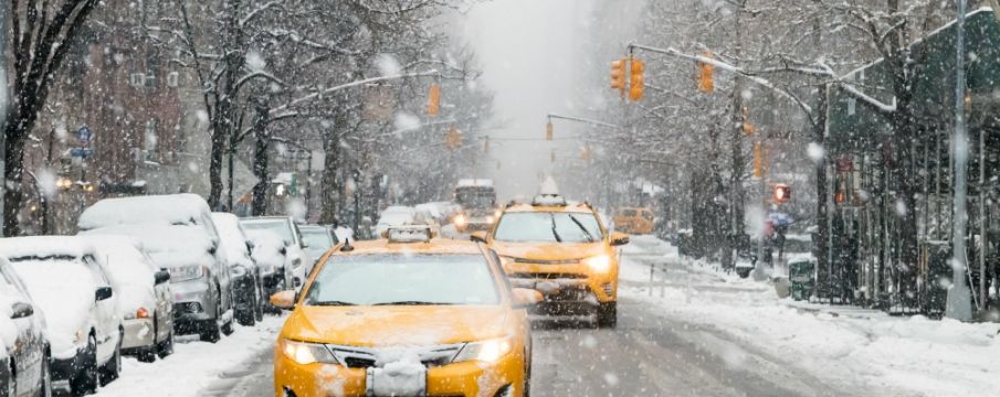 Taxis driving through NYC in the snow