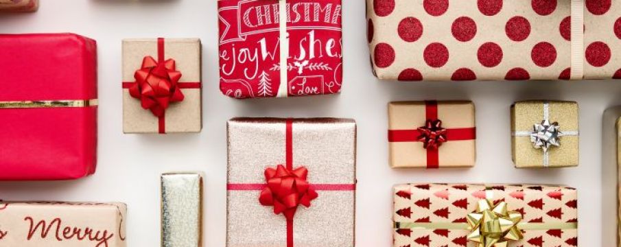 a photo of a number of different sized present boxes lined up all wrapped in designs of red and white paper