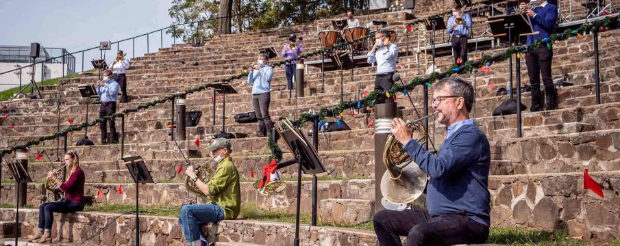 musicians playing instruments outside in holiday gear