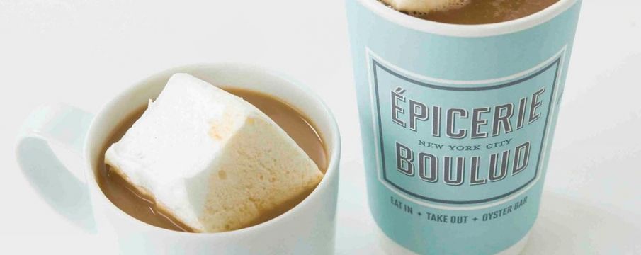 hot cocoa in a mug and in a to-go cup sitting next to each other from Epicerie Boulud