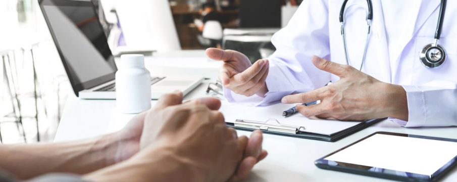 doctor reaching out to patients hand