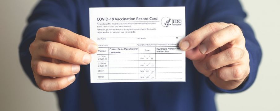 person holding vaccine card