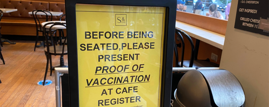 LSBID Staff photo of vaccine requirement signage at Shakespeare & Co. Cafe's indoor dining area