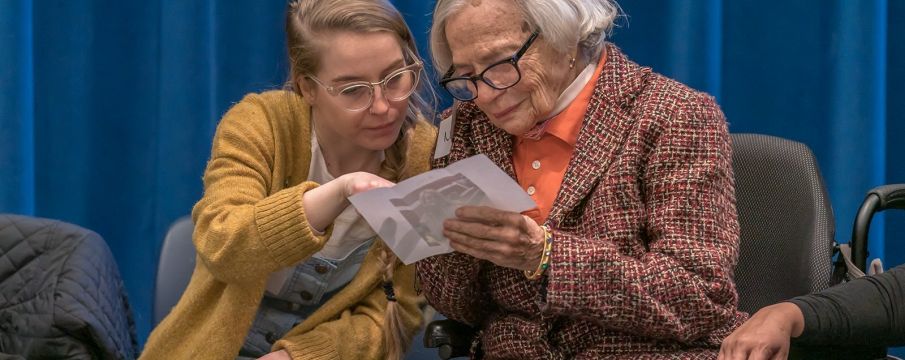 girl showing photo to older woman